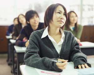 University Students Sitting in a Classroom, Young Woman Looking Up