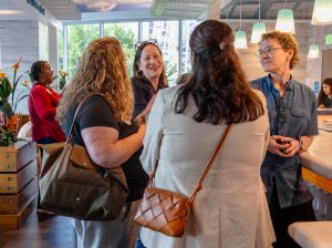 Attendees chat during the summer institute welcome reception. Photo credit: Jenna Ayoub.