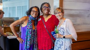 Rachel Grant, Natalie Tindall and Angela Bradbery enjoy reuniting at the summer institute welcome reception. Photo credit: Jenna Ayoub.