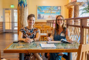 Jessica Osegueda, University of Florida’s College of Journalism and Communications event manager, and Andrea Desky, are ready to check people in at the summer institute welcome reception. Photo credit: Jenna Ayoub.