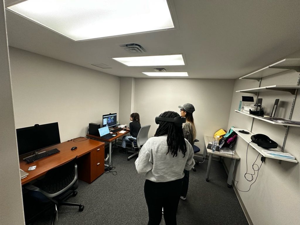 Students working with virtual reality equipment.