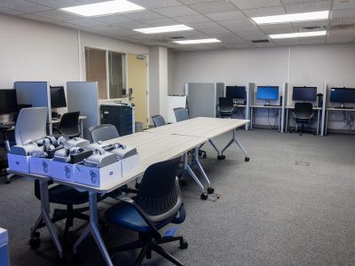 A view of the lab showing workstations, meeting table and VR headsets.
