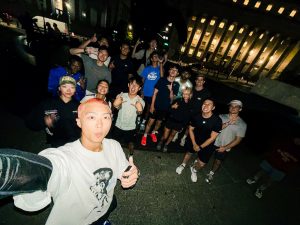 Group of young people outside at night in New York City.