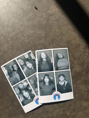 Two sets of photobooth photos on a table.